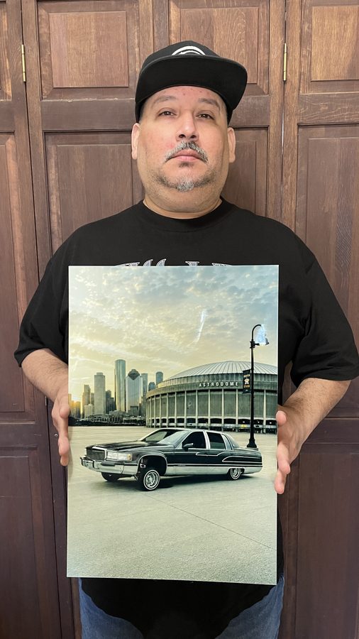 Customer holding metal print — Cadillac at the Astrodome